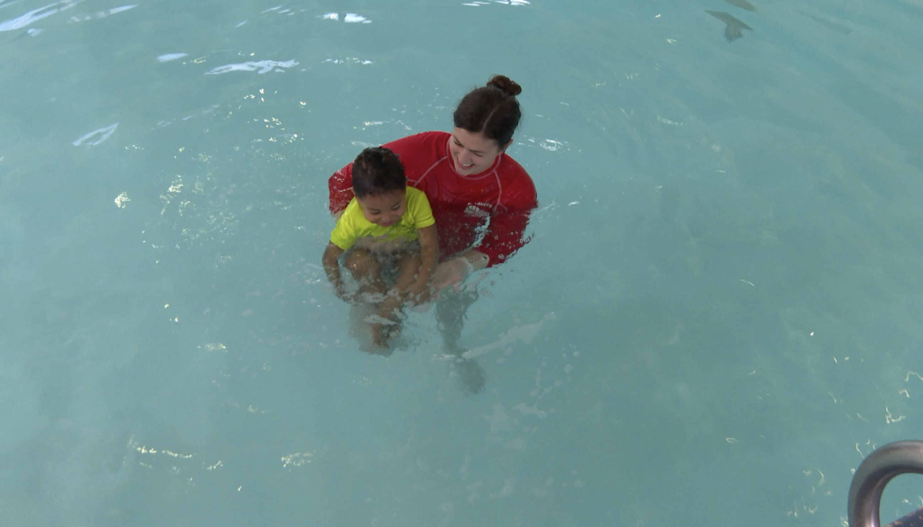 Child in poll with swim instructor