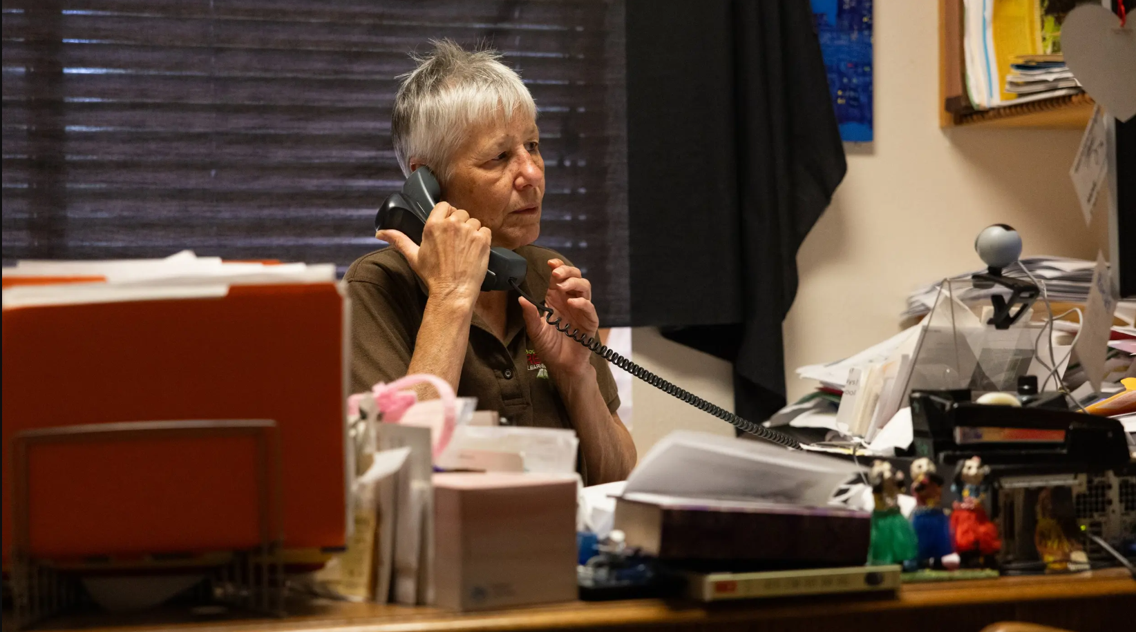Librarian Judith Bergeron answers the phone in her office at the Smithville Public Library in Smithville, Texas, on March 11, 2024.