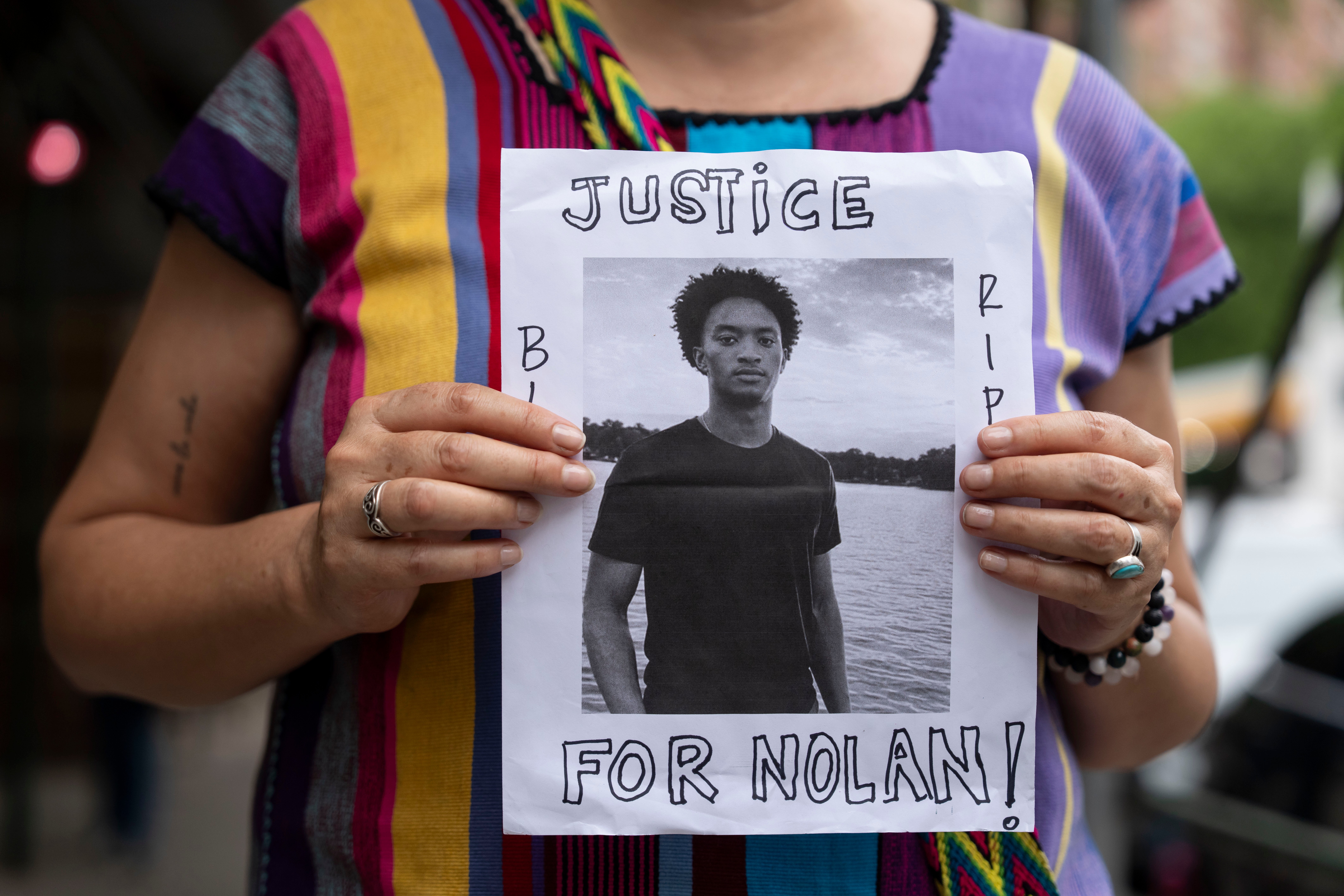 FILE - A person holds a picture of Nolan Xavier Wells during a news conference at National Action Network headquarters, Friday, July 10, 2026, in New York.
