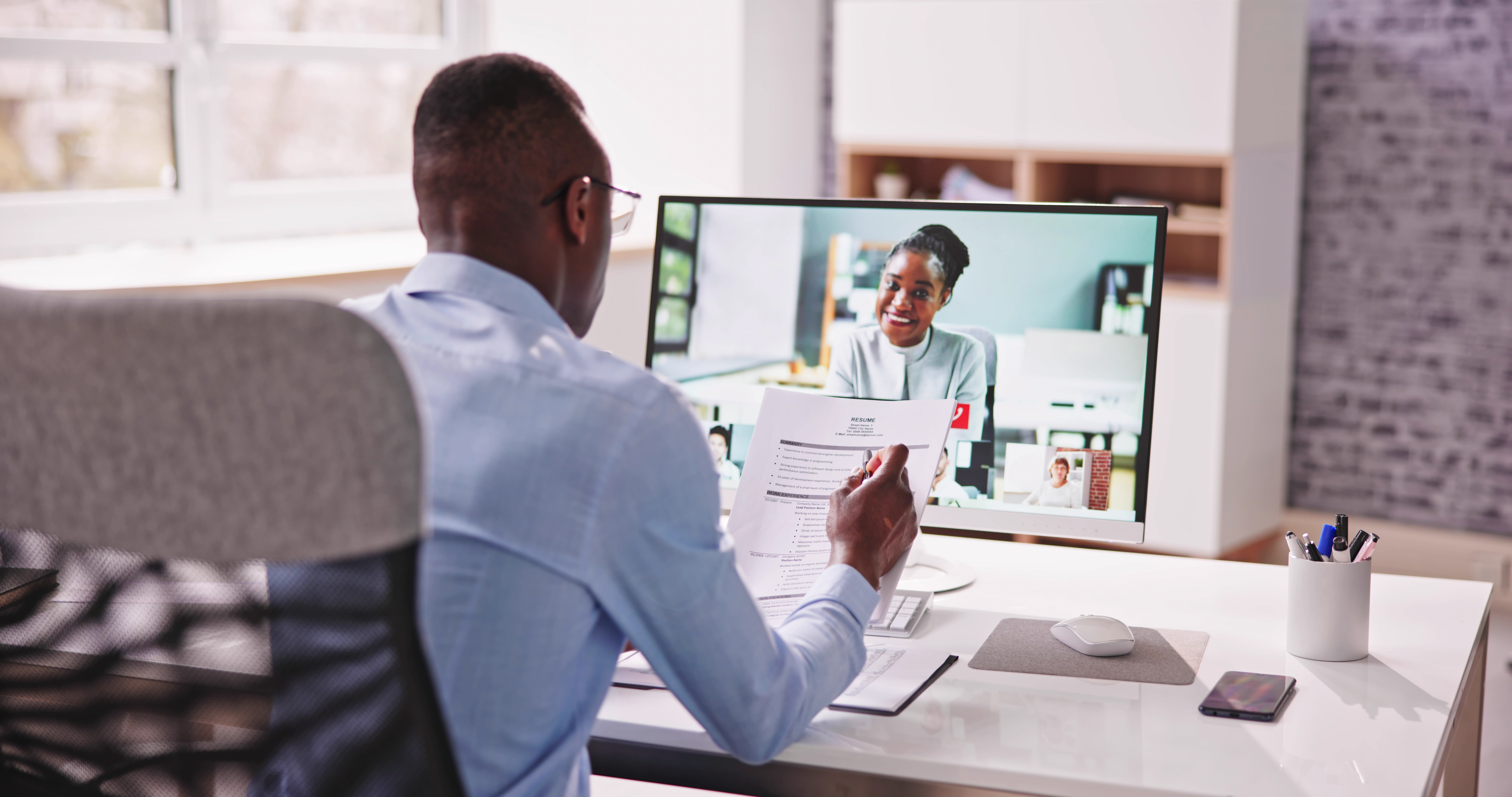 A person sits for a virtual job interview.