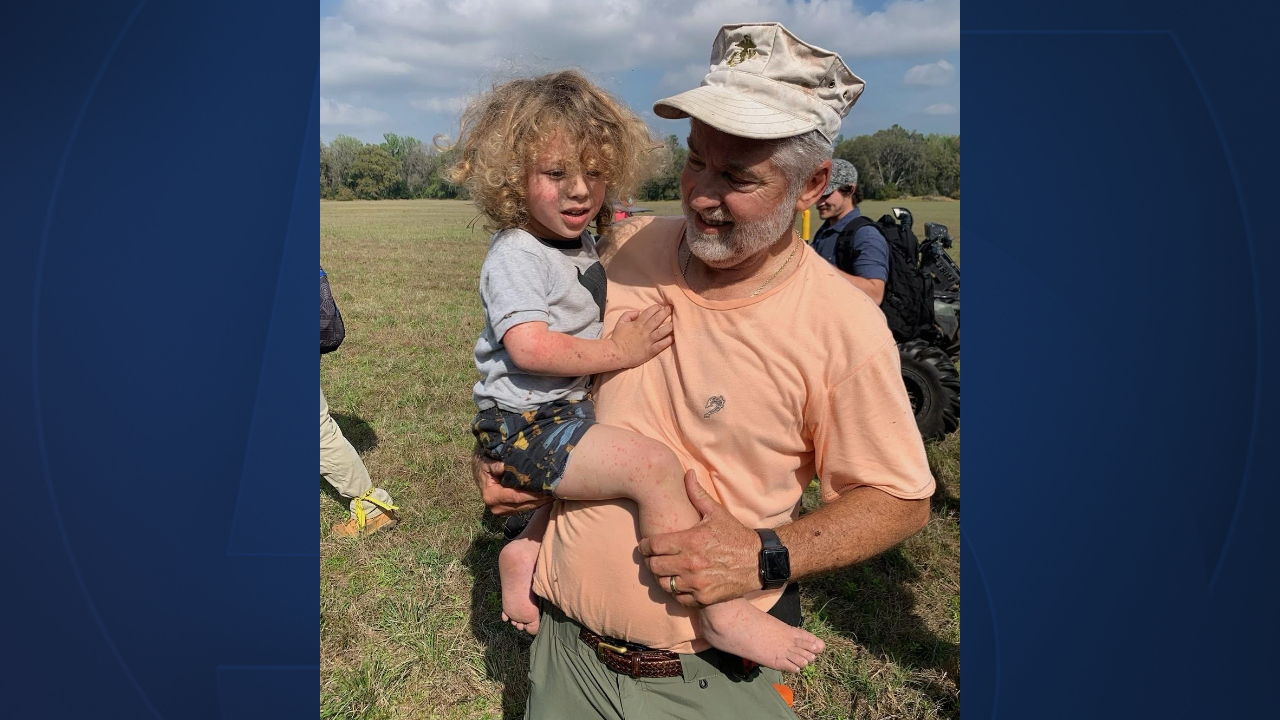 A volunteer searcher holds 2-year-old Joshua Rowland of Hernando County on Feb. 24, 2023.jpg