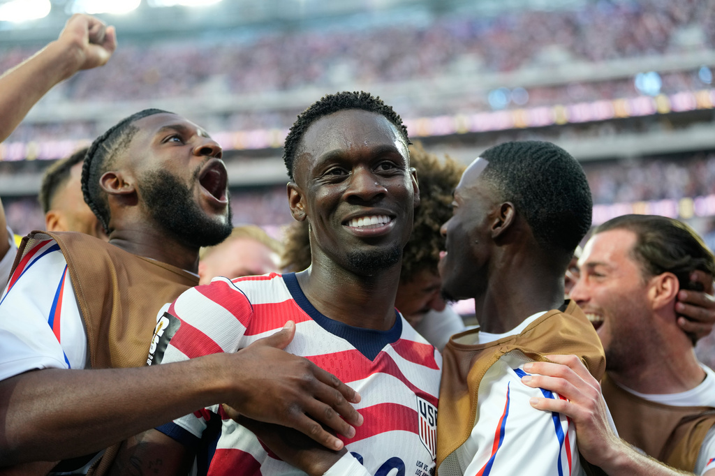 United States' Folarin Balogun, center, celebrates scoring his side's third goal against Paraguay with teamates during the World Cup Group D soccer match in Inglewood, Calif., near Los Angeles, Friday, June 12, 2026. 