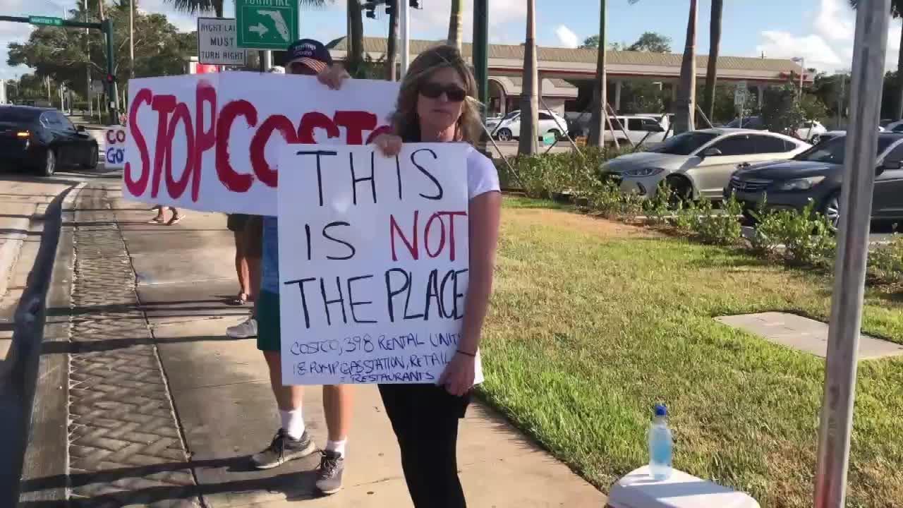 Costco protesters hold signs in Stuart, May 14, 2021