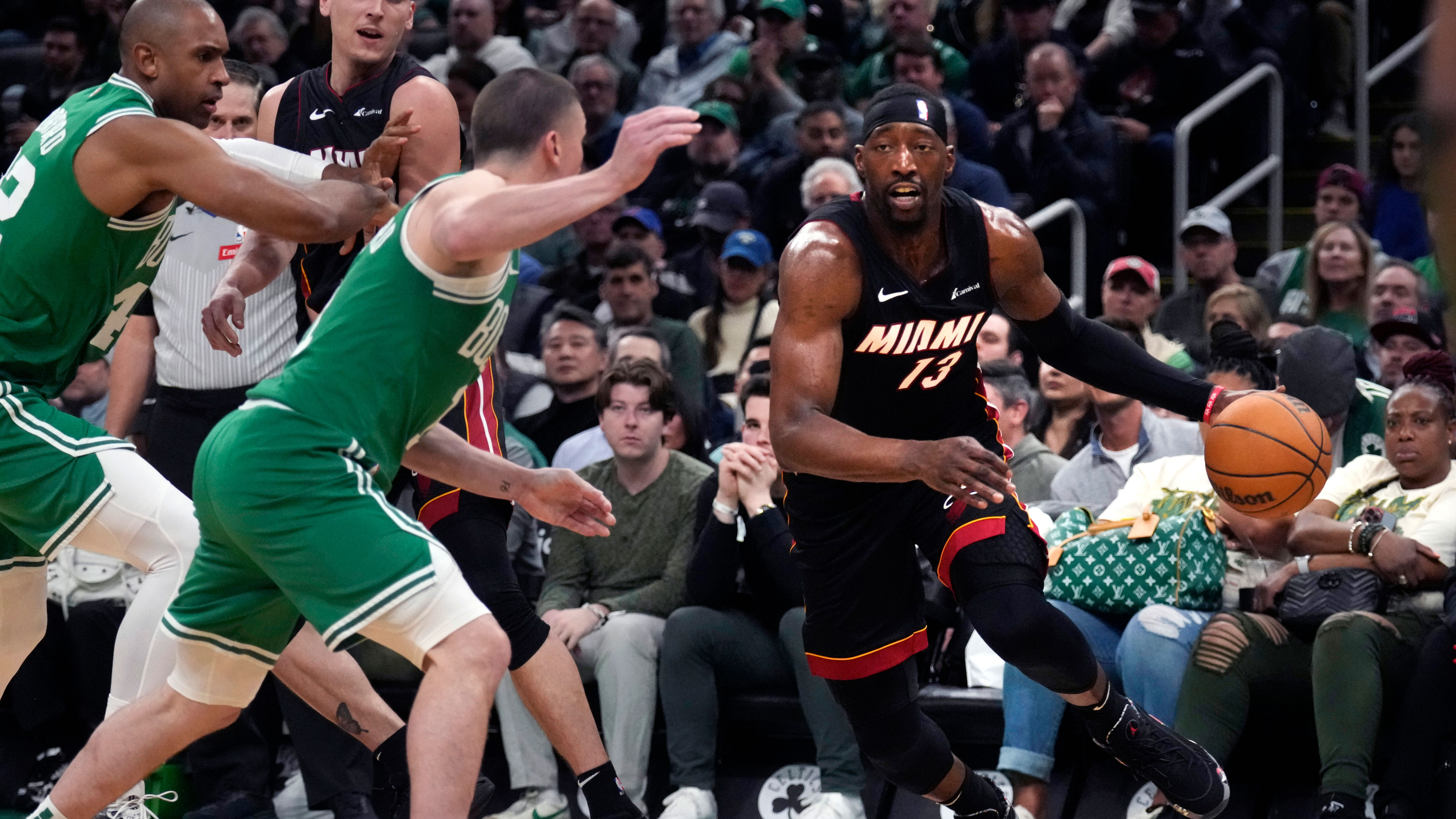 Miami Heat center Bam Adebayo, right, drives to the basket against the Boston Celtics during the second half of Game 2 of an NBA basketball first-round playoff series, Wednesday, April 24, 2024, in Boston. 