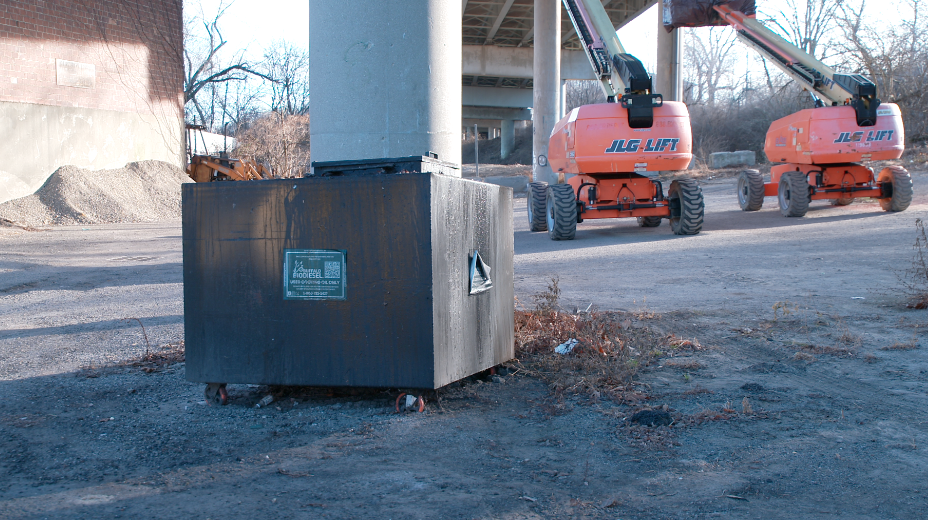 A dumpster of used cooking oil under the I-75 bridge over Benson Street in Lockland on Jan. 21, 2025. 