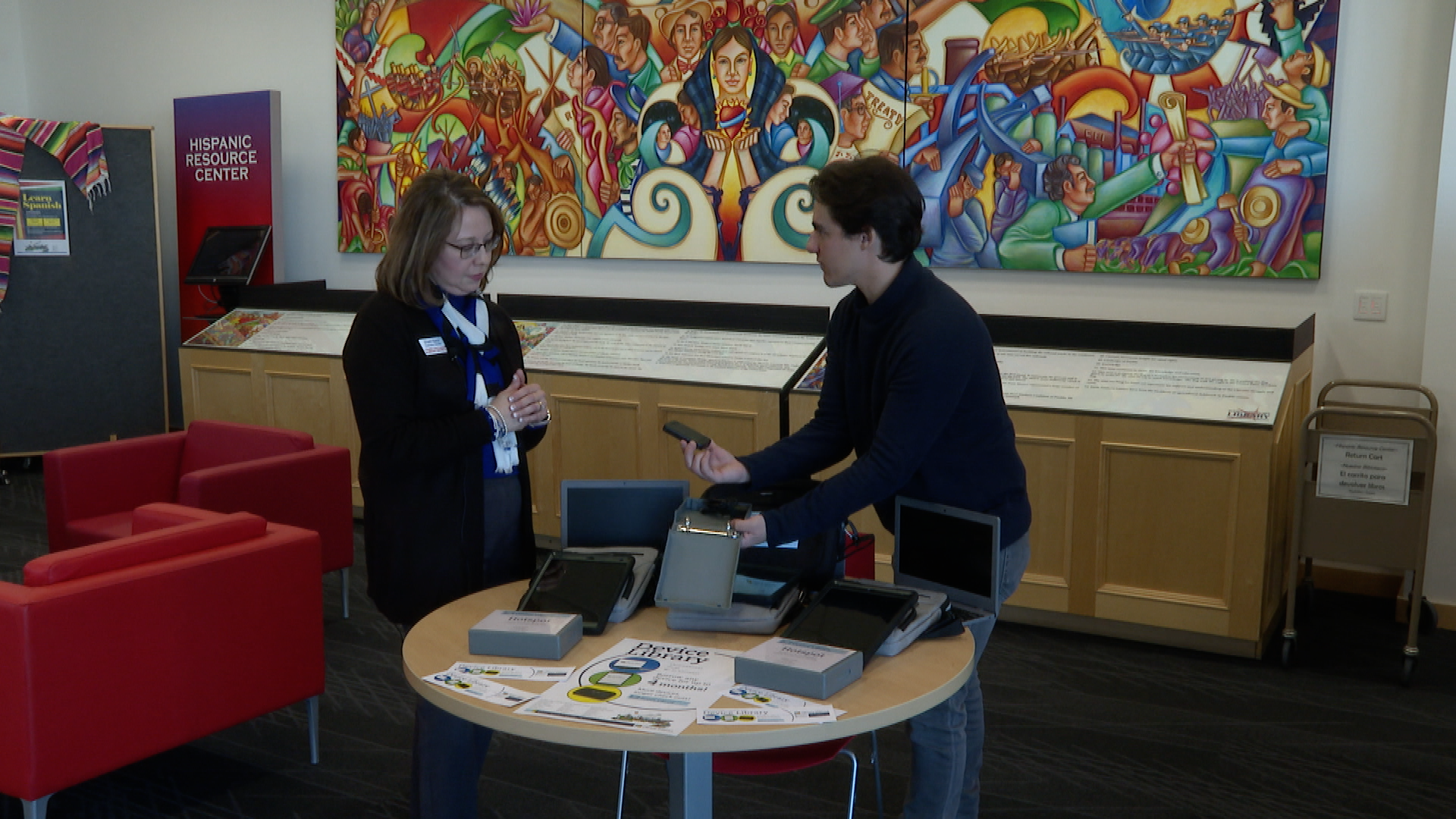 The executive director of the library shows News5's Devan Karp how a mobile hotspot works 