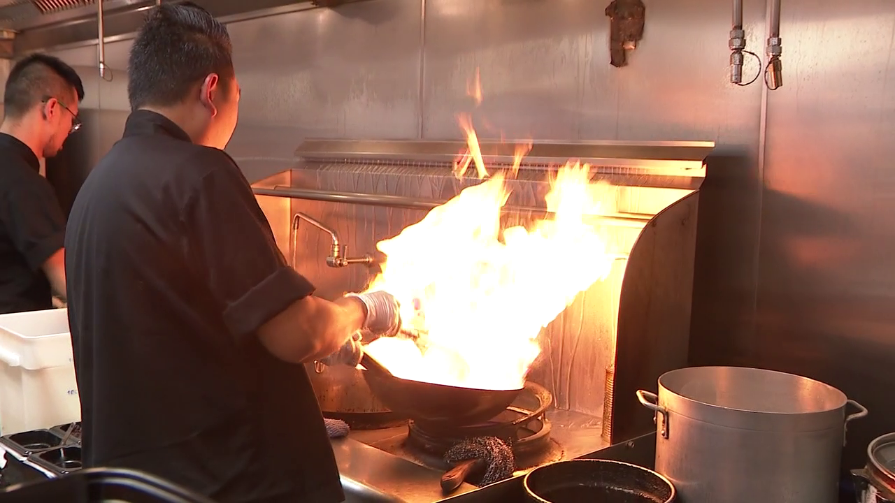 Chef prepares food at Daughter Thai Kitchen in Denver
