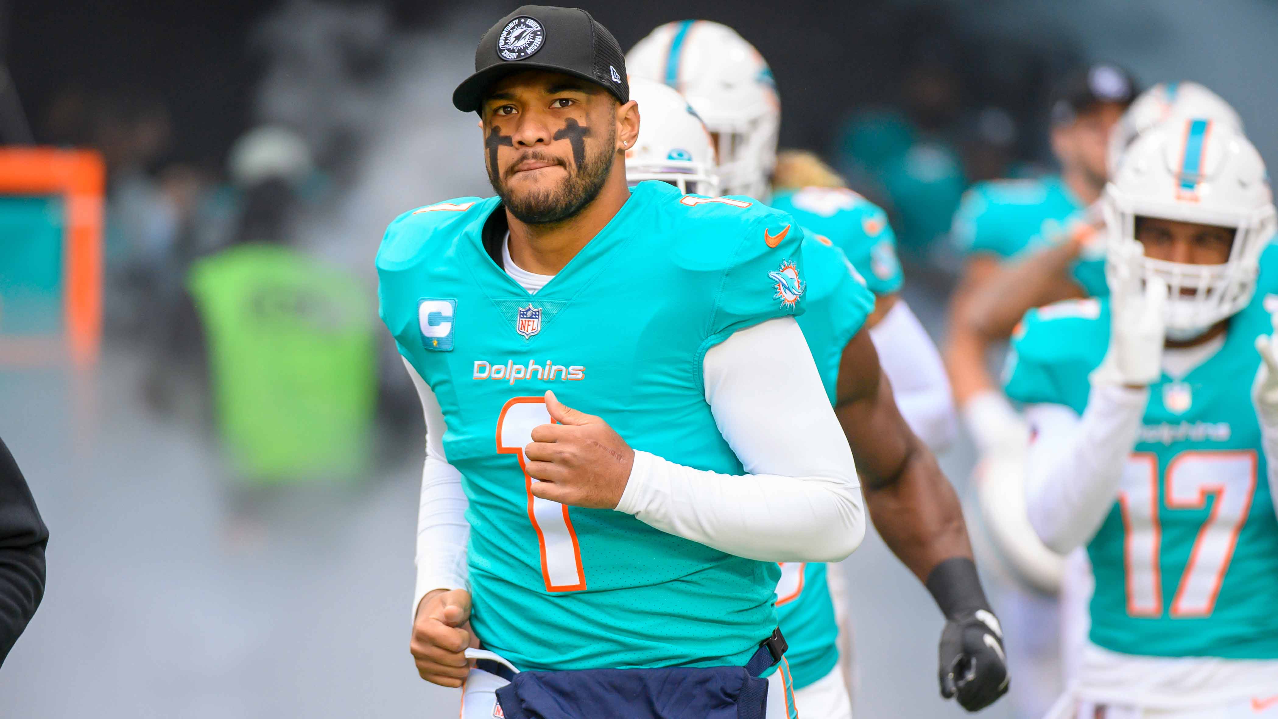 Miami Dolphins quarterback Tua Tagovailoa (1) runs onto the field before an NFL football game against the Green Bay Packers, Sunday, Dec. 25, 2022, in Miami Gardens, Fla.