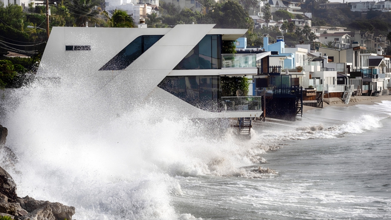 Waves smash against a home along the California coast in Malibu Beach, Calif. on Friday, Dec. 29, 2023.