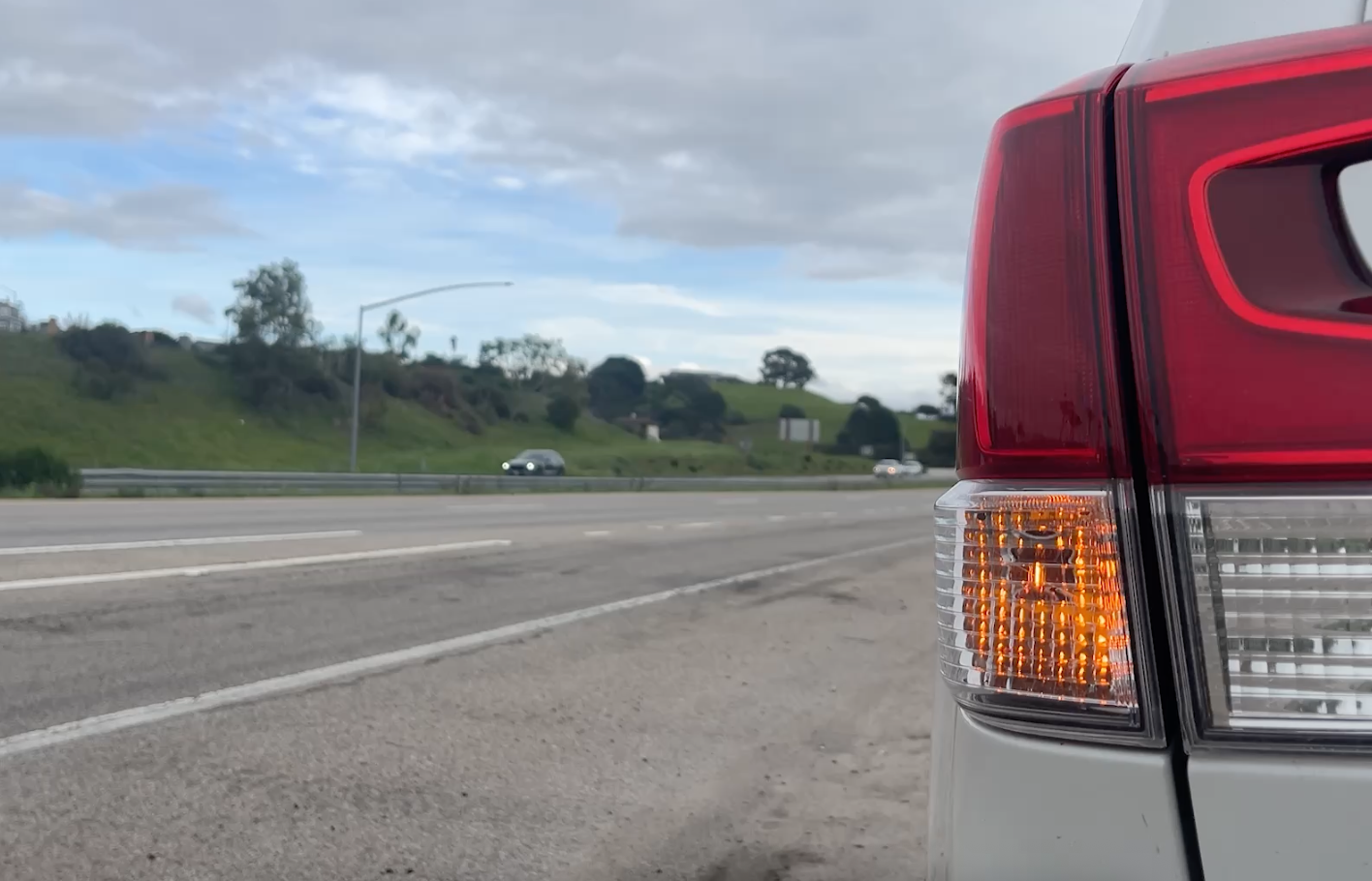 Car on highway shoulder