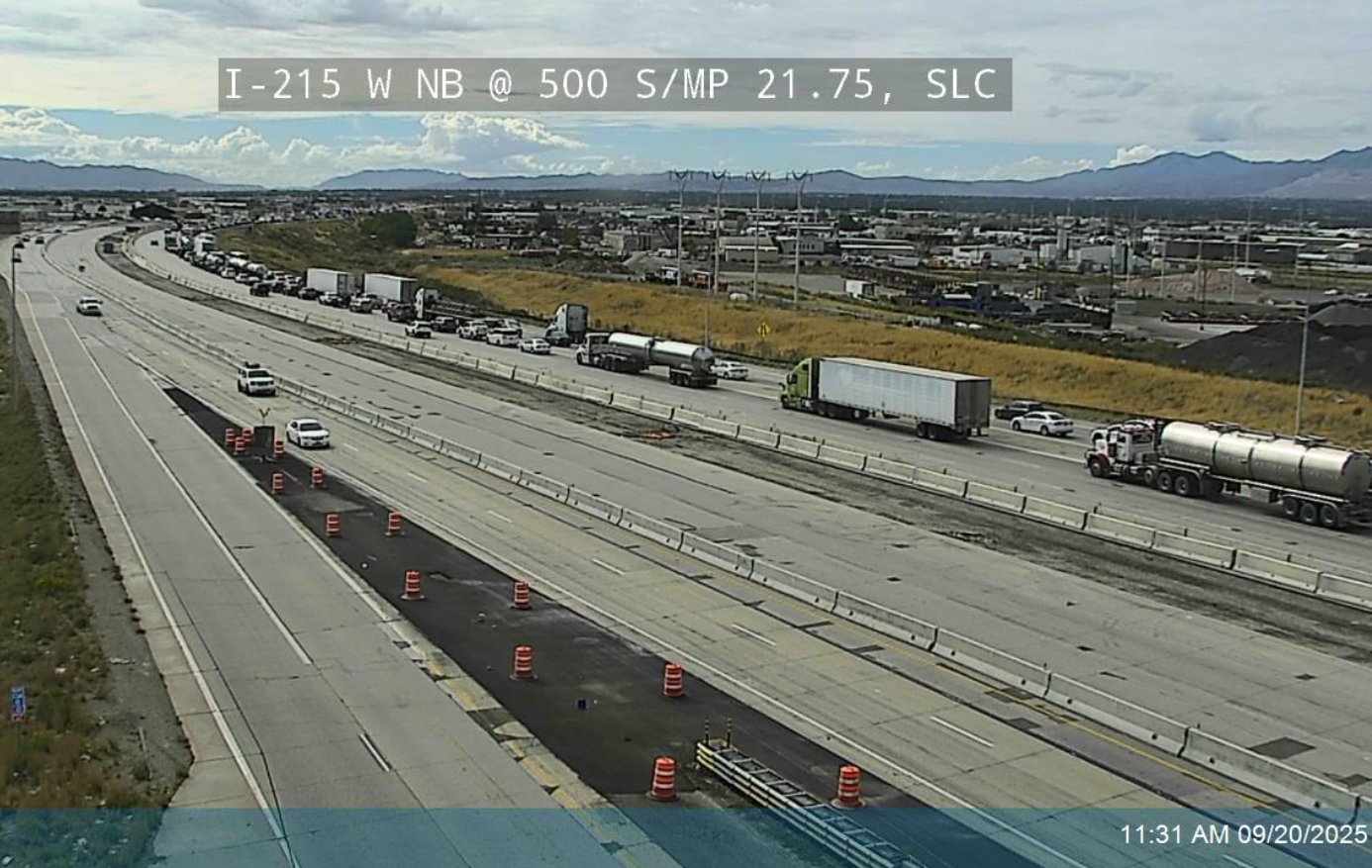 A snapshot from a UDOT traffic camera showing the area affected by the closure. It's daylight, and there's a large space where a concrete barrier would normally be that has been paved over.