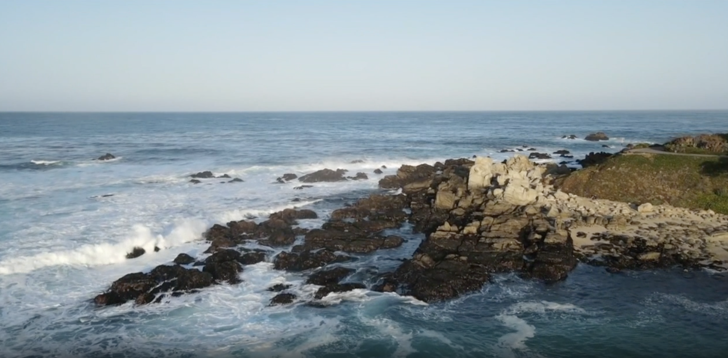 Waves crash along the coast.