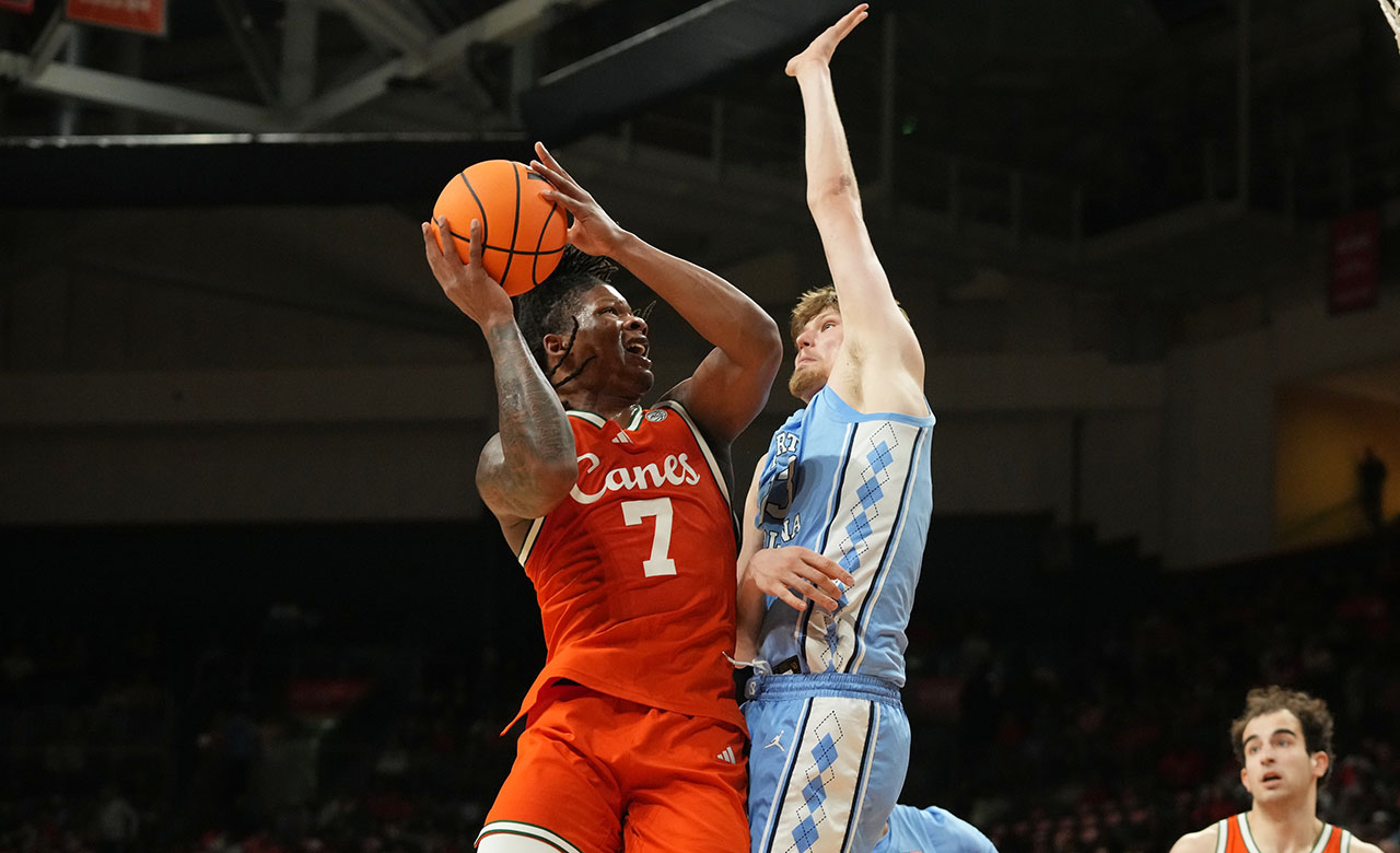 Miami forward Shelton Henderson (7) drives to the basket as North Carolina center Henri Veesaar (13) defends during the first half of an NCAA college basketball game, Tuesday, Feb. 10, 2026, in Coral Gables, Fla.