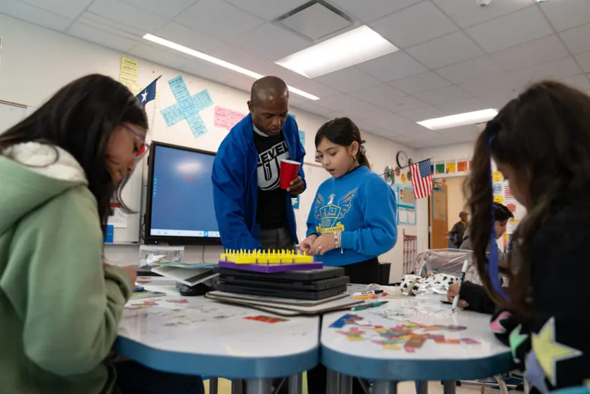 Third grade teacher Eran McGowan works through math problems with his students at the Eddie Bernice Johnson STEM Academy in Dallas on Feb. 5. 