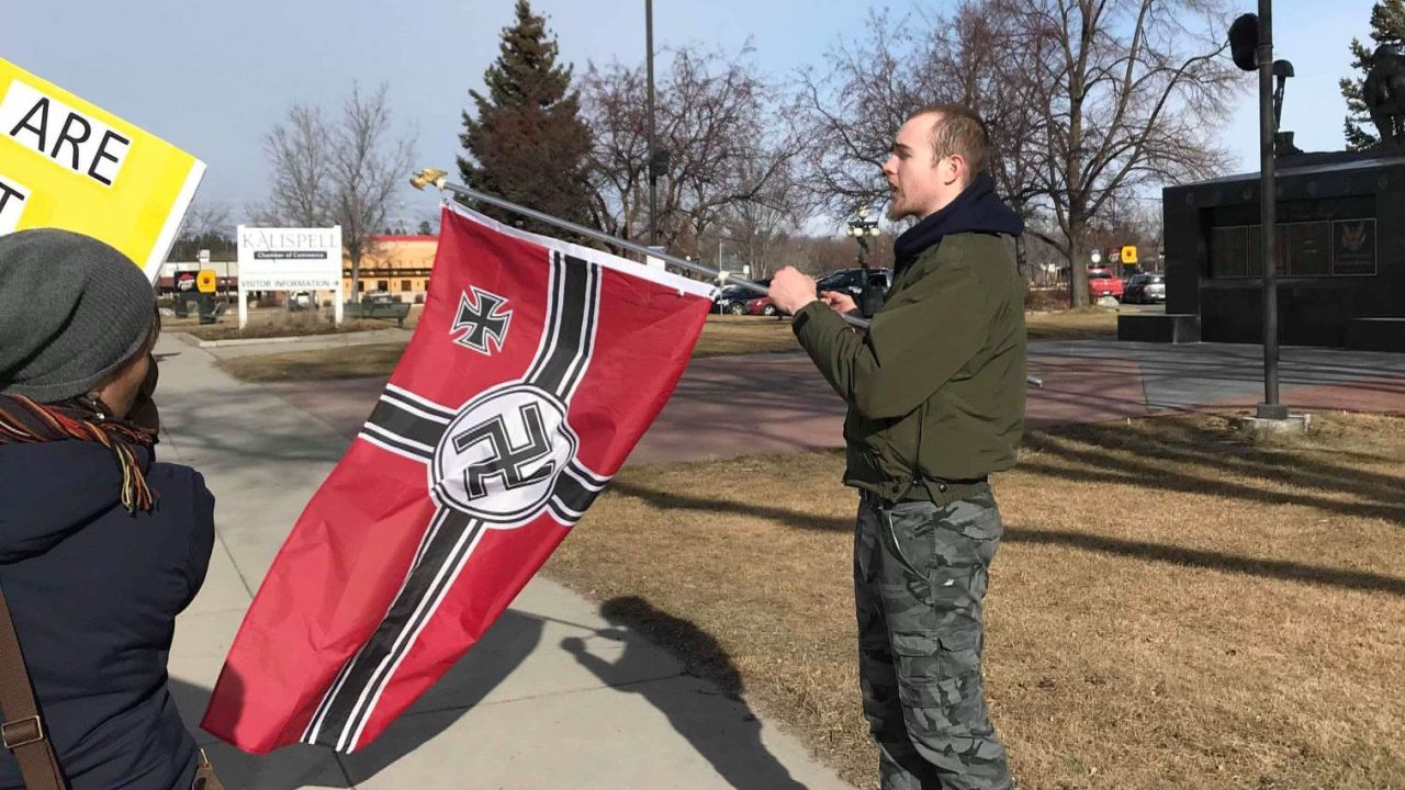 Love Lives Here In The Flathead Valley - photo of man holding Nazi flag
