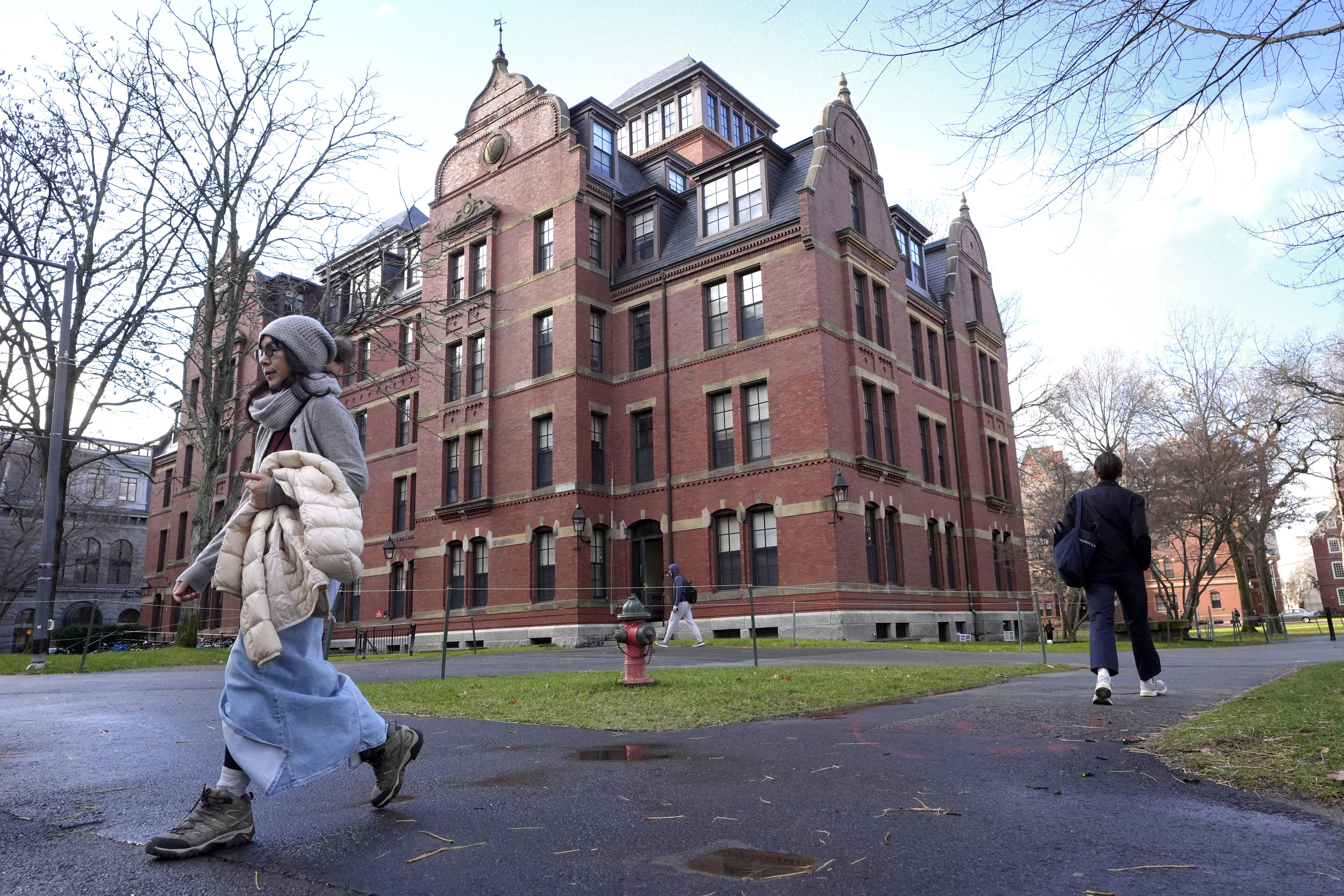People walk between buildings on Harvard University campus, Dec. 17, 2024, in Cambridge, Mass. 