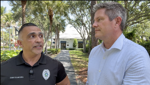 WPTV Anchor Mike Trim listens to Tequesta Police Chief Gus Medina.png