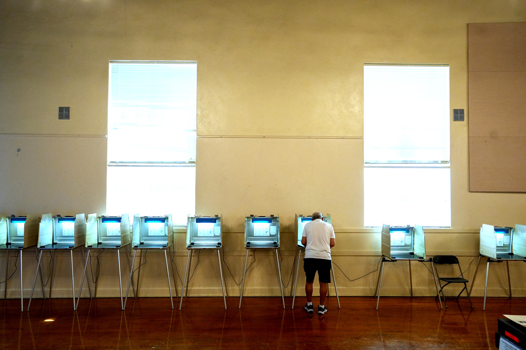 A voter marks his ballot at a polling precinct in Sacramento, Calif., Tuesday, June 2, 2026.