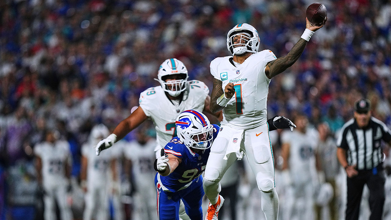Miami Dolphins quarterback Tua Tagovailoa (1) passes the ball while pressured by Buffalo Bills defensive end Joey Bosa (97) during the first half of an NFL football game, Thursday, Sept. 18, 2025, in Orchard Park, N.Y.  