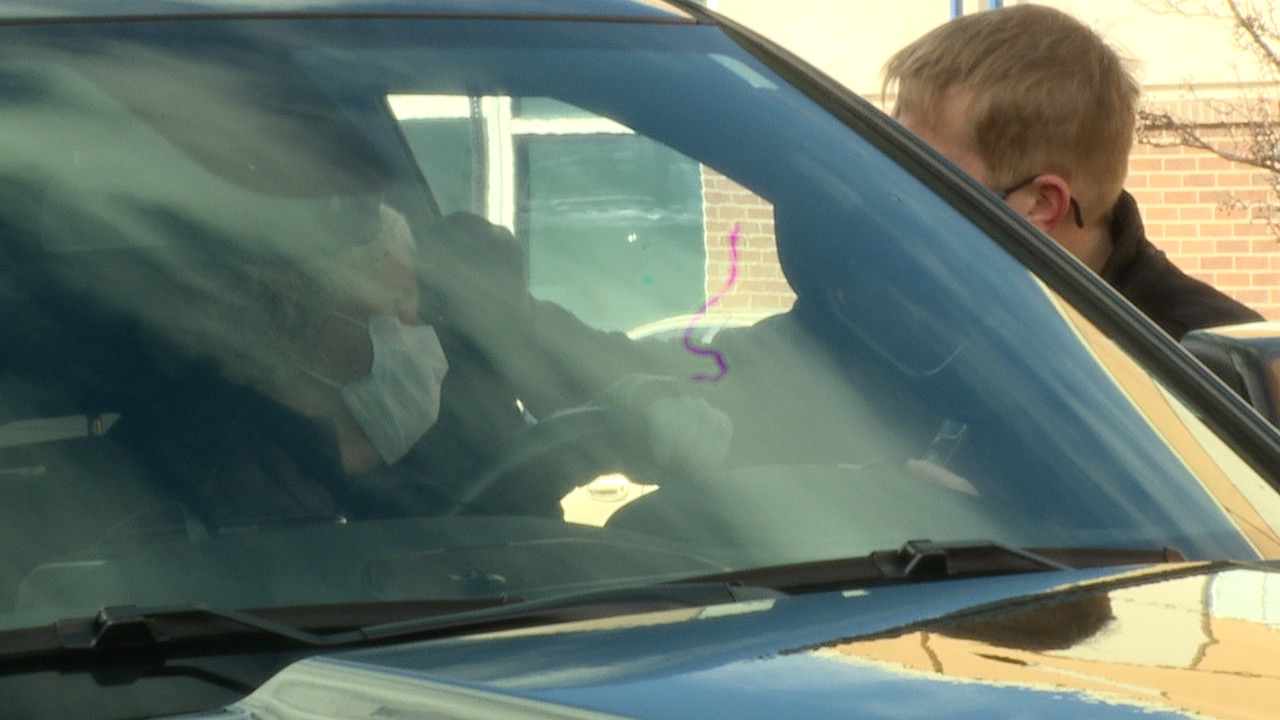 Pastor Andrew Kukla administers ashes during a drive thru service on Wednesday .jpg