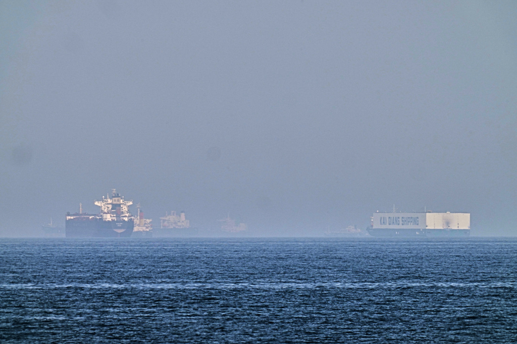 A tanker, left, and a car carrier are anchored at sea in the Gulf of Oman near the Strait of Hormuz, as seen from the coast near Khor Fakkan, United Arab Emirates, Friday, May 1, 2026.