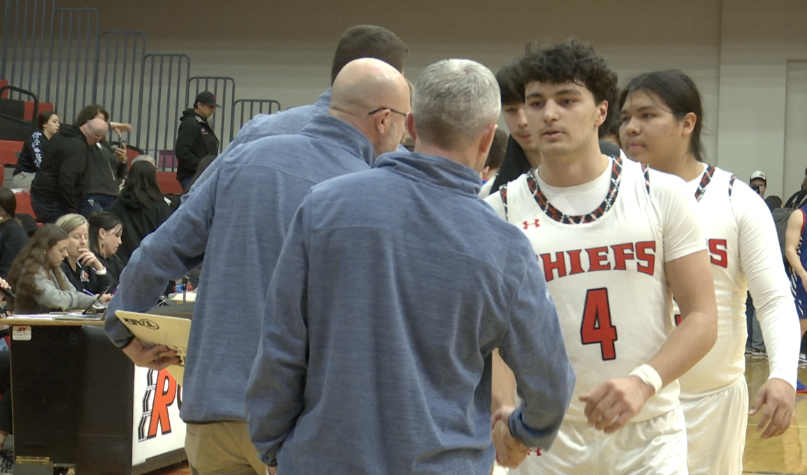 Ronan Boys Basketball players shake hands with Columbia Falls coaches postgame, Ronan