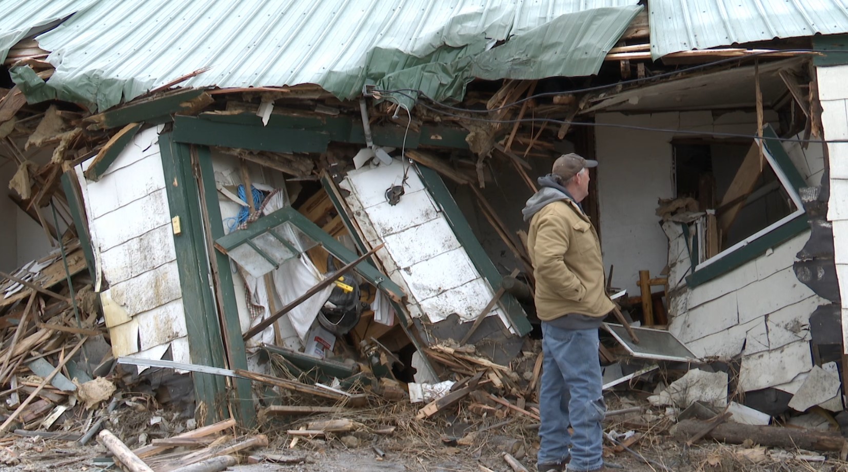 Jim Amadon looks into his destroyed wood works shop