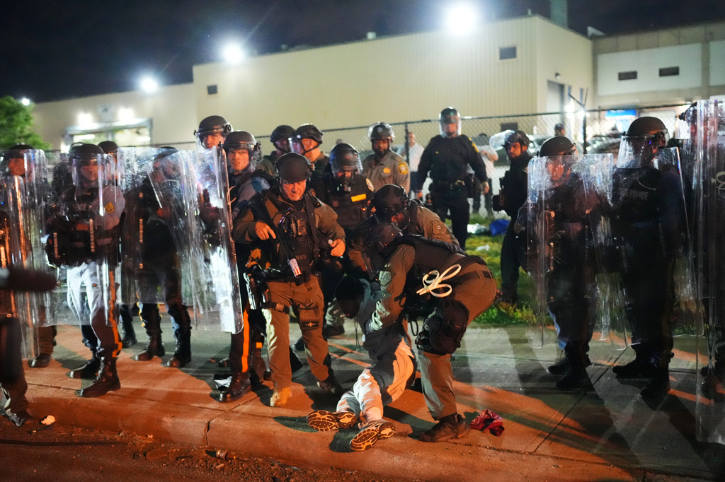 Law enforcement officers detain a person outside Delaney Hall detention center Sunday, May 31, 2026, in Newark, N.J. 