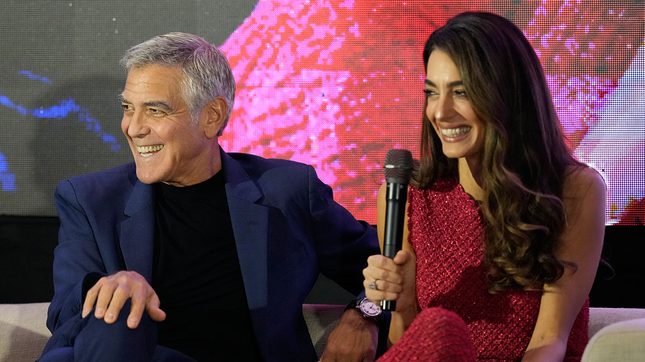 Couple George and Amal Clooney smile as they attend the Social Good Summit in Pasay City, Philippines, Sunday, Nov. 16, 2025.