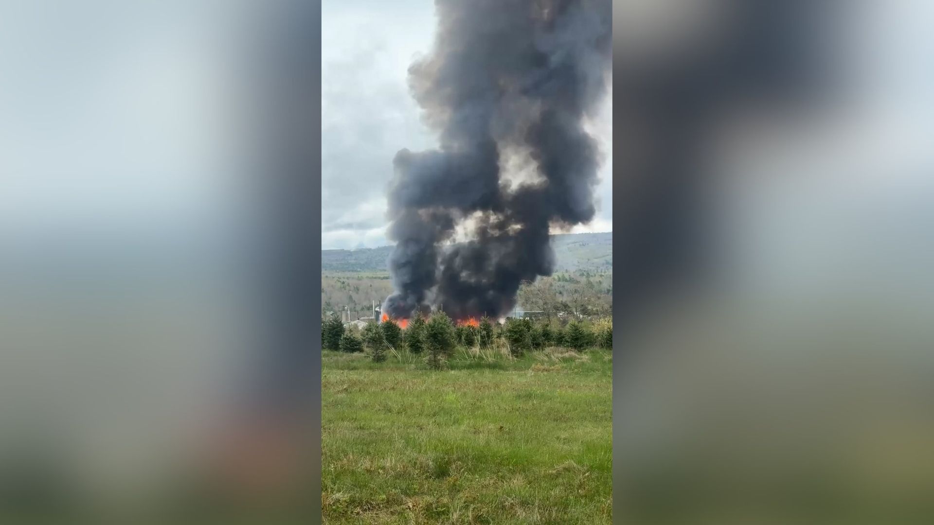 A plume of smoke from a large fire at Robbins Lumber in Searsmont