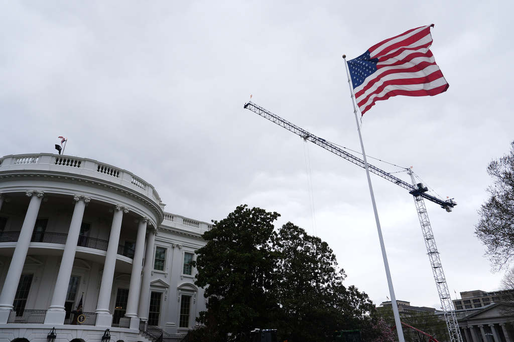 An American flag waves on the South Lawn of the White House, Friday, March 27, 2026, in Washington. 