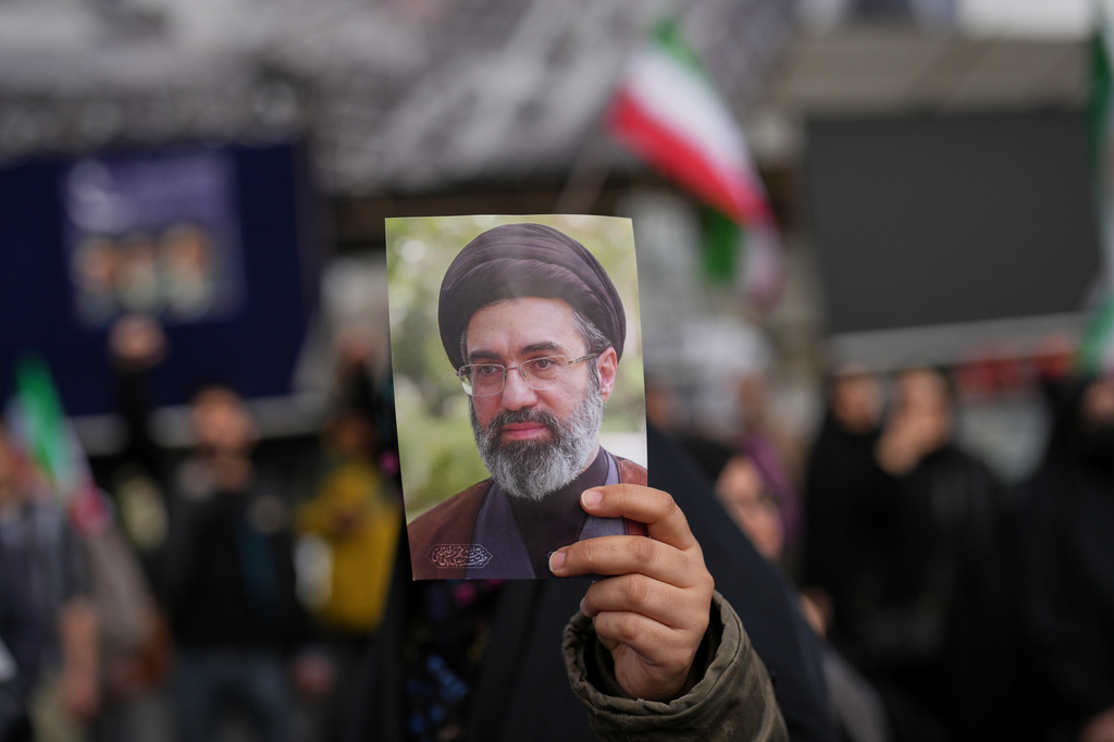 A demonstrator holds a picture of Iran's Supreme Leader Mojtaba Khamenei during a gathering after announcement of a two-week ceasefire with the United States and Israel, in Tehran, Iran, Wednesday, April 8, 2026. 