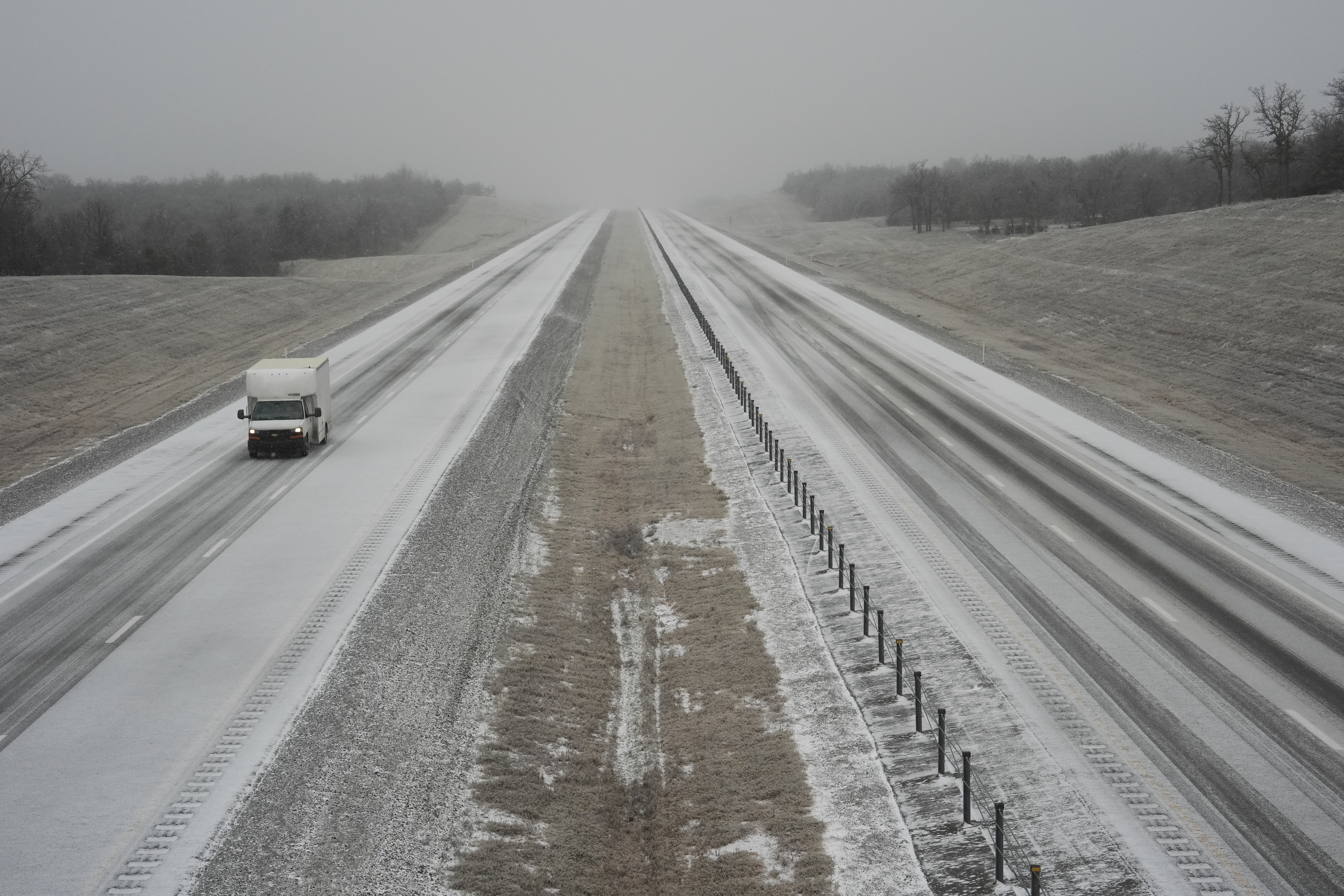 A truck drives along Interstate 335 during a winter storm, Tuesday, Feb. 18, 2025, near Luther, Okla. 