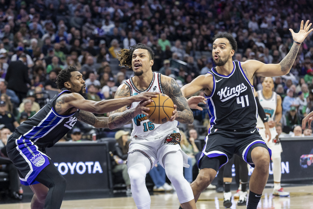 Sacramento Kings guard Malik Monk, left, blocks Memphis Grizzlies forward Brandon Clarke (15) as he goes up for a layup during the second half of an NBA basketball game Monday, March 17, 2025, in Sacramento, Calif.