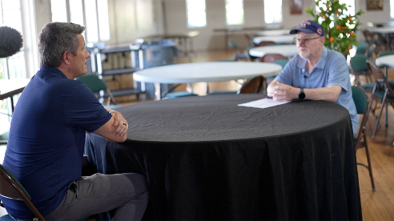 WPTV anchor Mike Trim listens to Thomas Clark about his waste management fees increasing at his condo during a WPTV's Let's Hear it meetup in Vero Beach. 