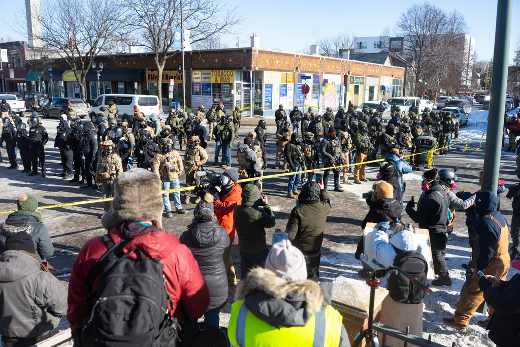 A large crowd gathers at the scene where federal agents fatally shot Alex Pretti in Minneapolis, Minn., on Saturday, Jan. 24, 2026. 
