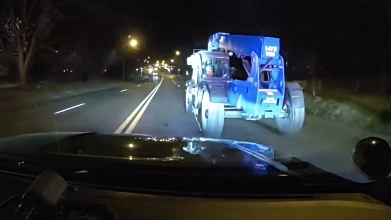 Police dash camera footage shows officers pursuing a stolen construction vehicle.