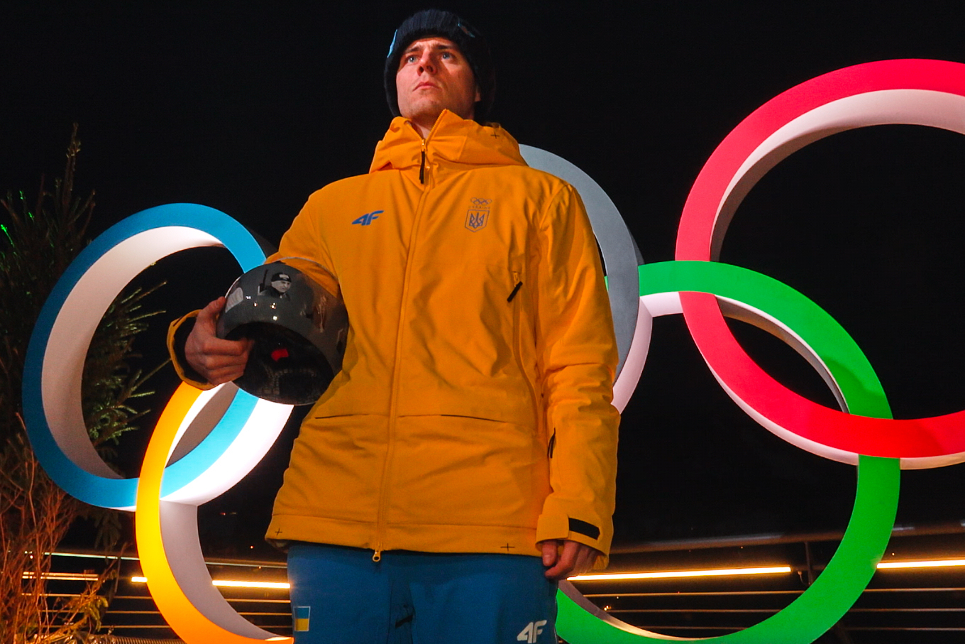 Ukraine's Vladyslav Heraskevych holds up his crash helmet during a press conference following a skeleton training session at the 2026 Winter Olympics, in Cortina d'Ampezzo, Italy, Tuesday, Feb. 10, 2026.