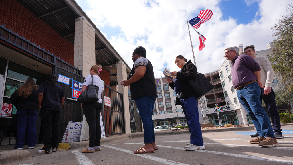 Primary voters line up to cast ballots at a voting center in Dallas, Tuesday, March 3, 2026. 