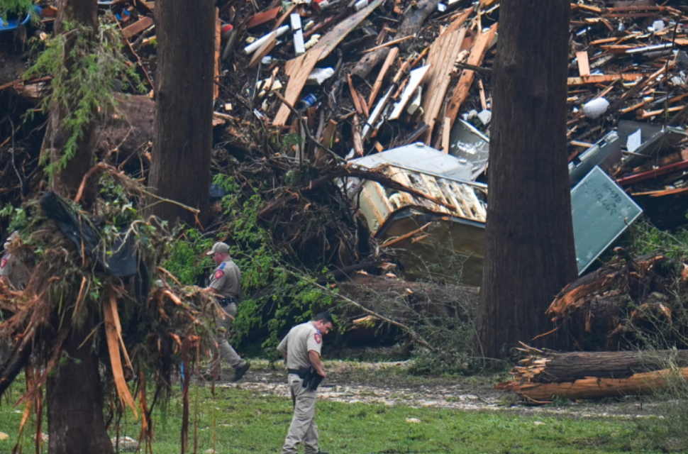Families sifted through waterlogged debris Sunday and stepped inside empty cabins at Camp Mystic, an all-girls summer camp ripped apart by flash floods that washed homes off their foundations and killed at least 82 people in central Texas