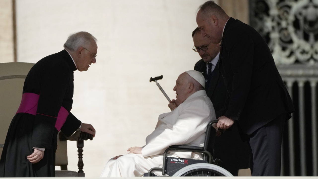 Pope Francis talks with Monsignor Leonardo Sapienza