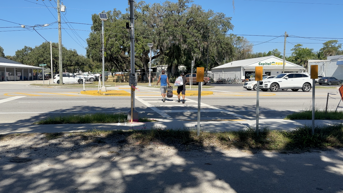 Two men using crosswalk
