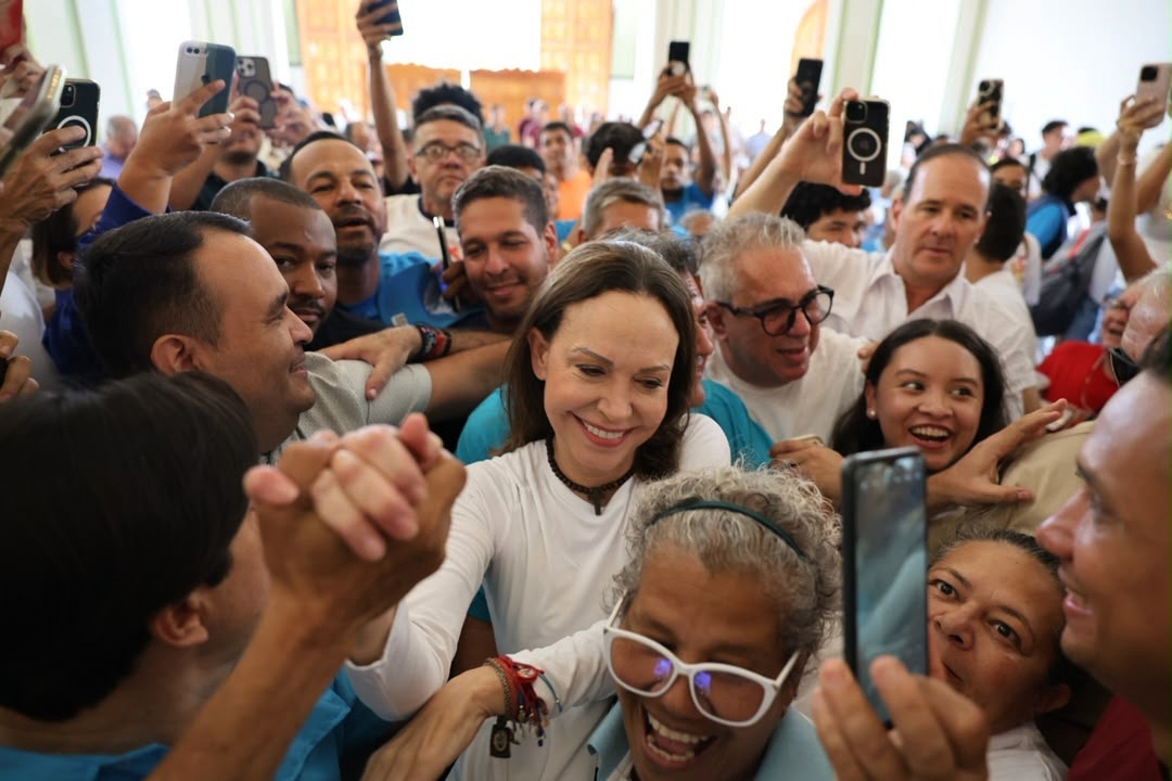 In this photo released by Vente Venezuela Press Office, Venezuelan opposition leader Maria Corina Machado greets supporters at a church in Barquisimeto, Venezuela, Sunday, Oct. 25, 2026.