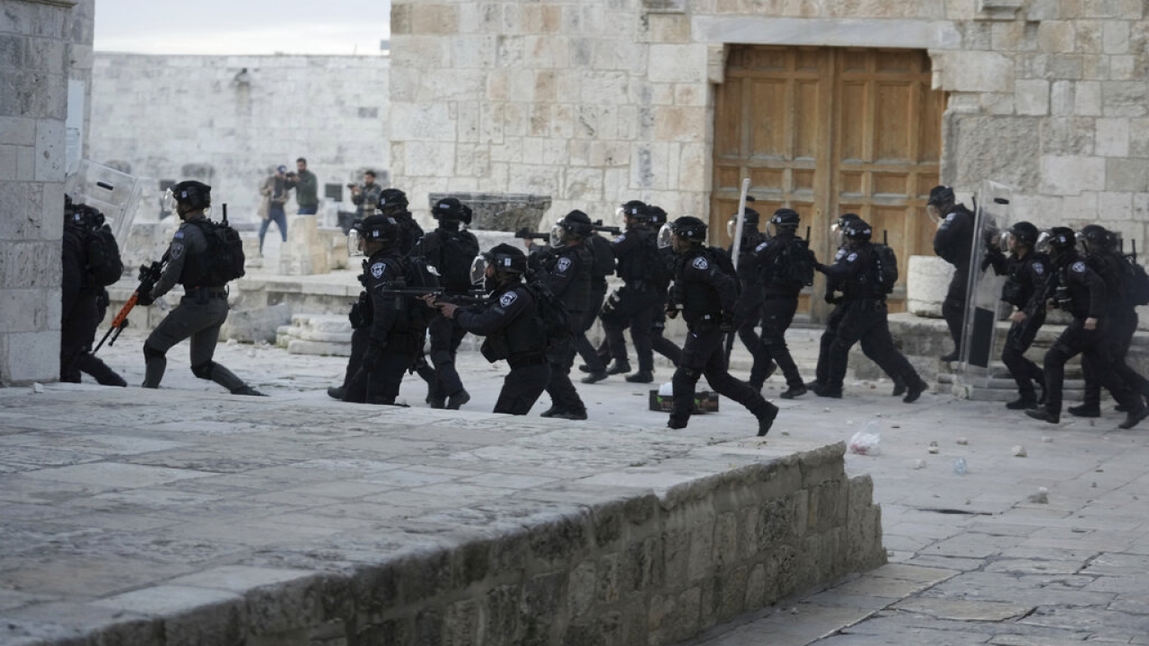 Israeli police enter the Al Aqsa Mosque compound where they clashed with Palestinian protesters.