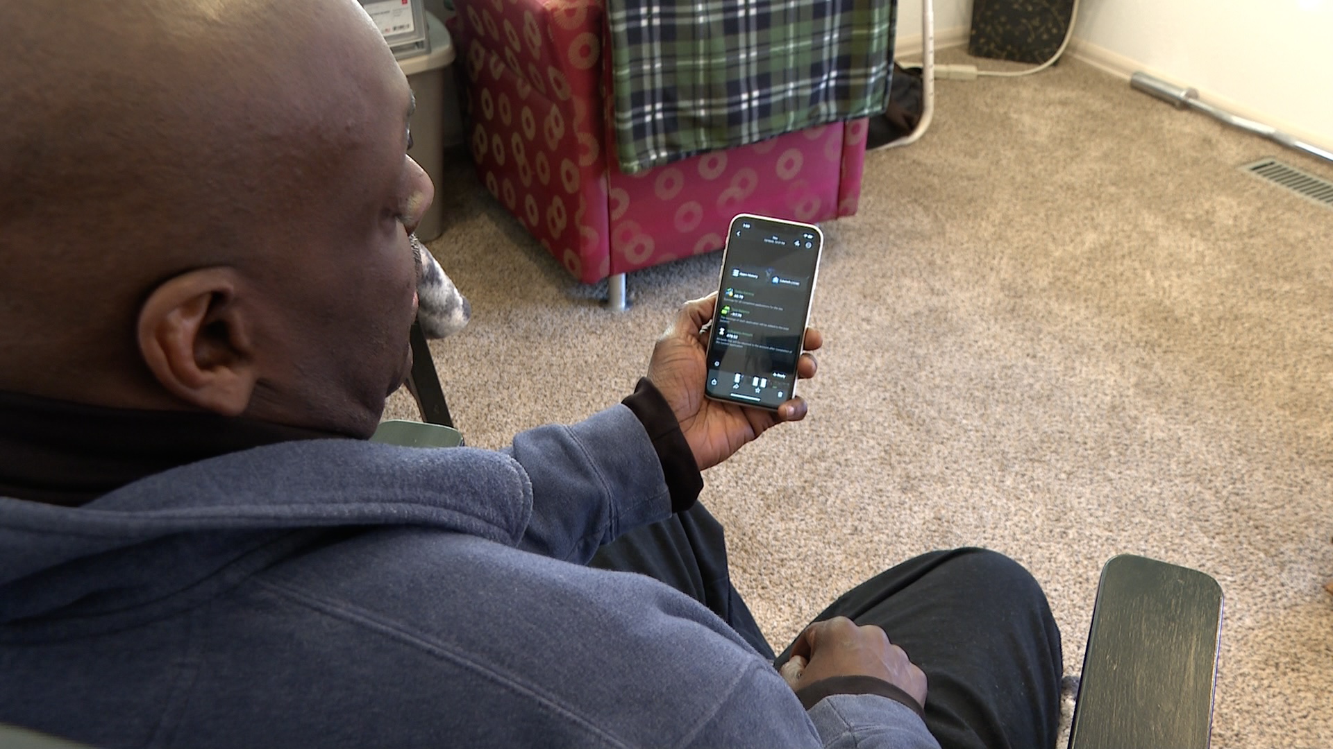 Man looks at phone after escaping fake job opportunity