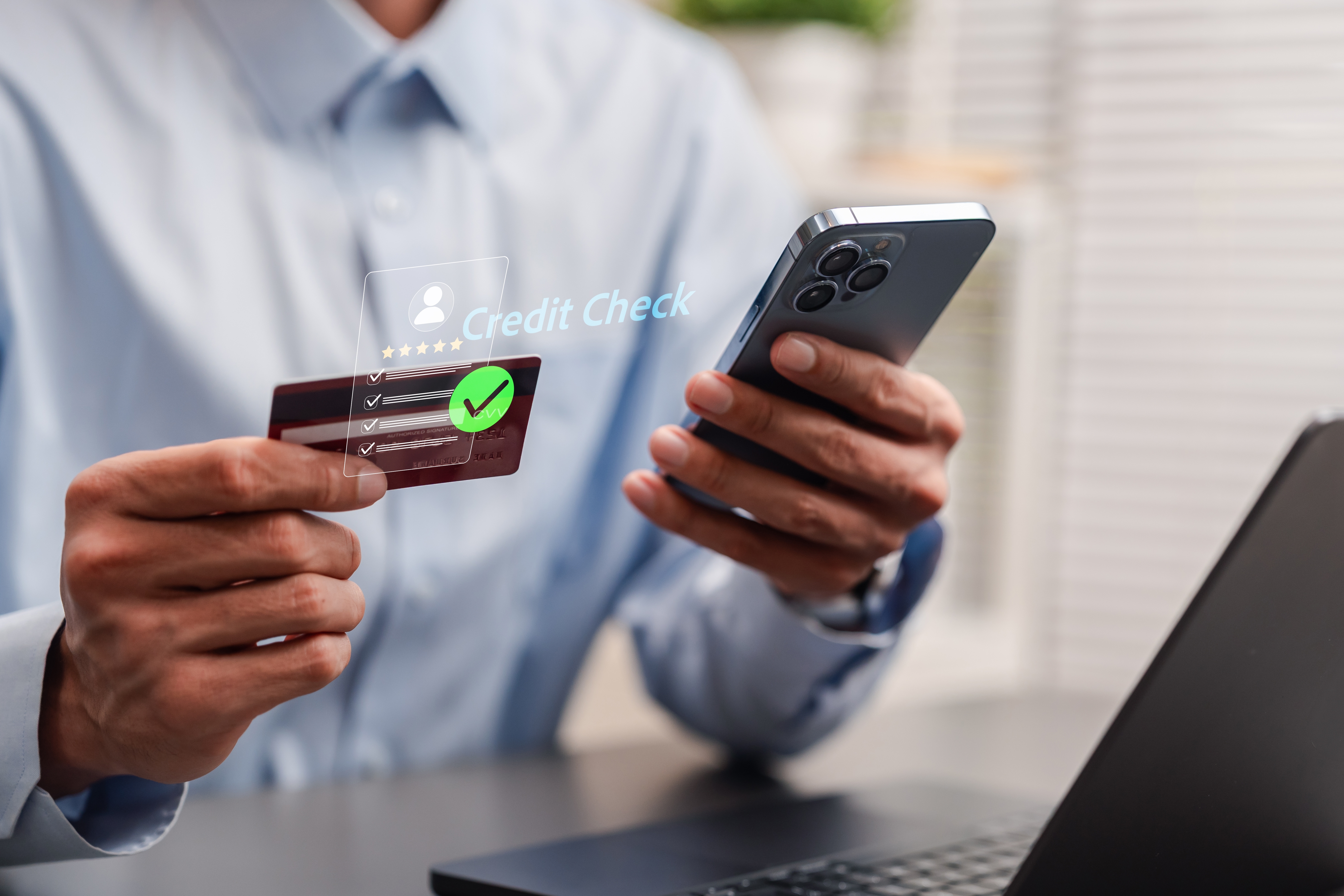A man with his phone and credit card. 