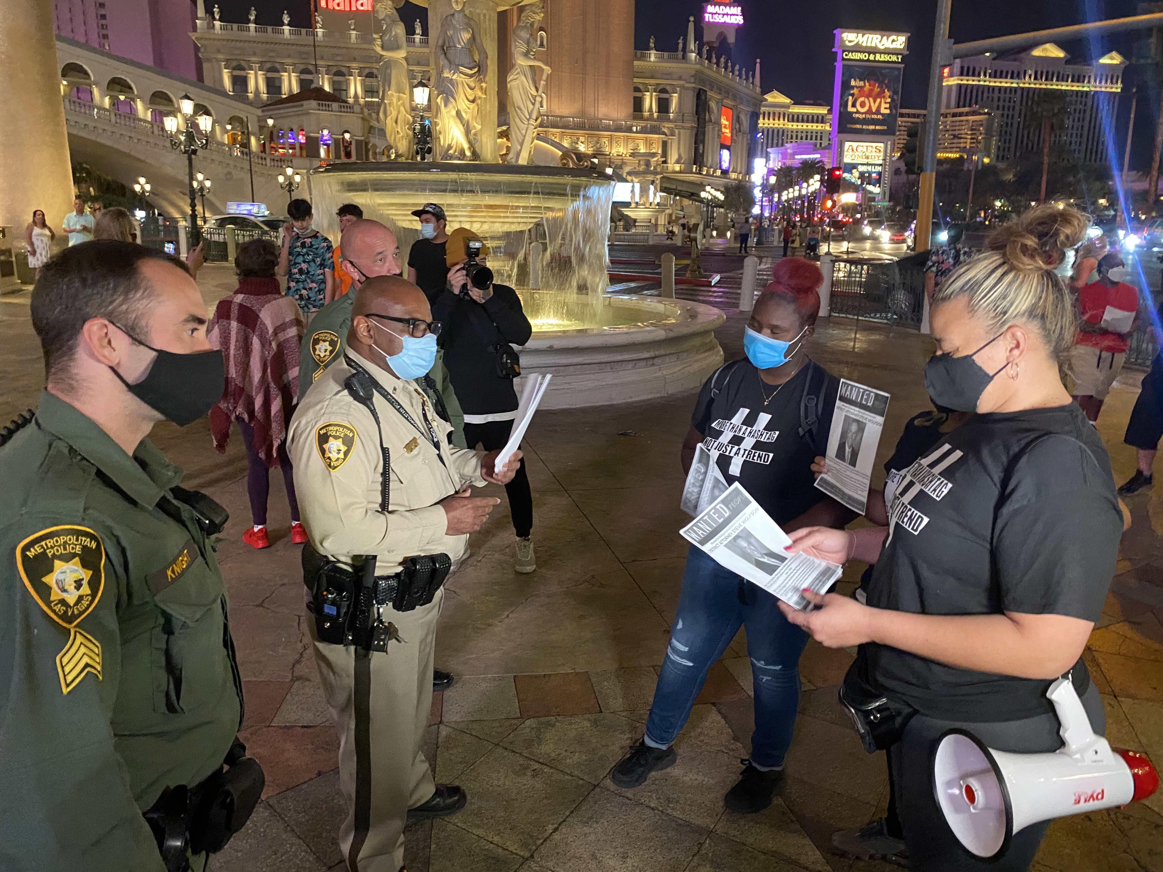 A small group met face to face with some Las Vegas Metro police officers on Tuesday night in front of the Venetian hotel and casino before a short march to demand justice in another high profile police shooting death.