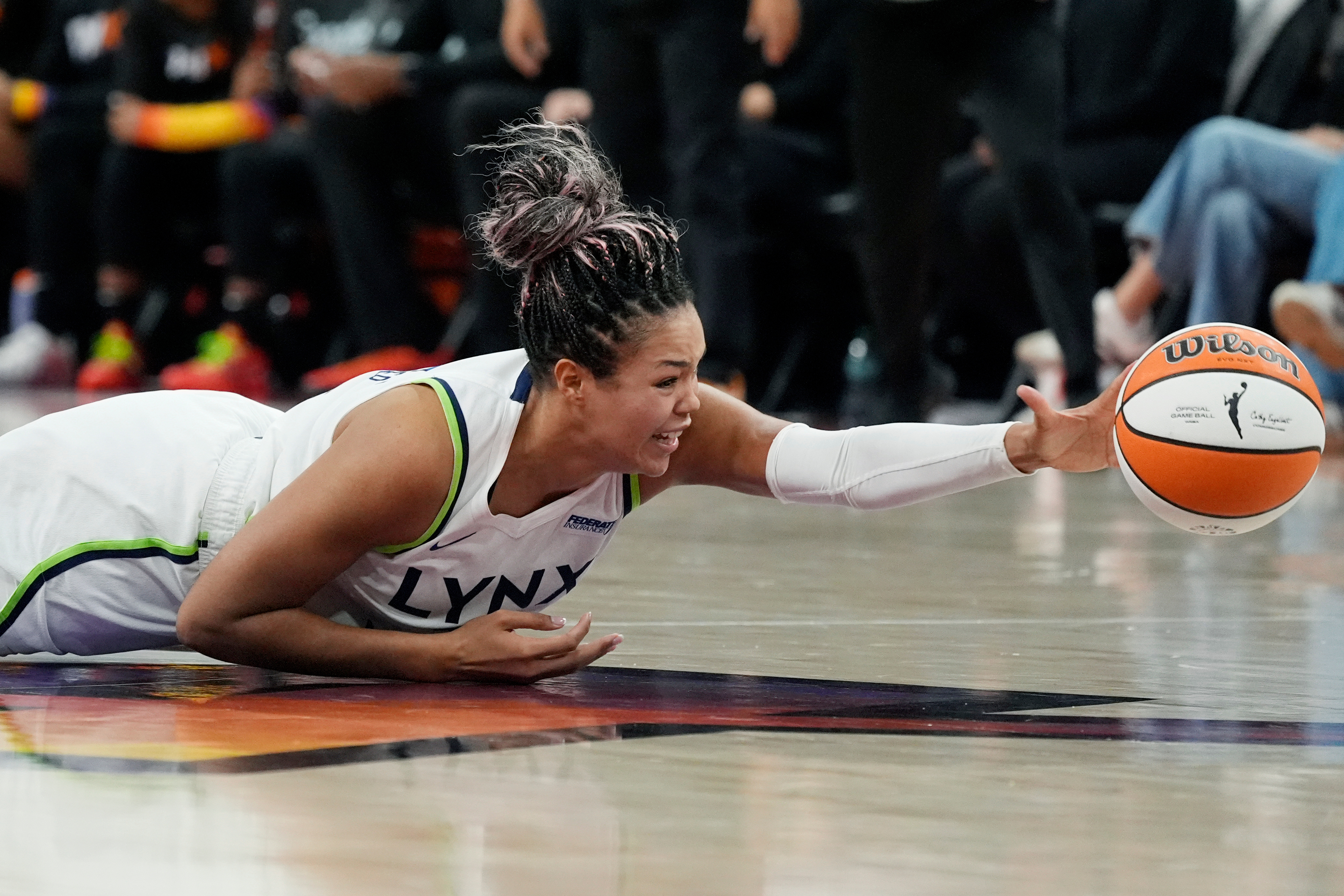 Minnesota Lynx forward Napheesa Collier dives after a loose ball during the first half of Game 3 of a WNBA basketball playoff semifinals series game against the Phoenix Mercury Friday, Sept. 26, 2025, in Phoenix. 