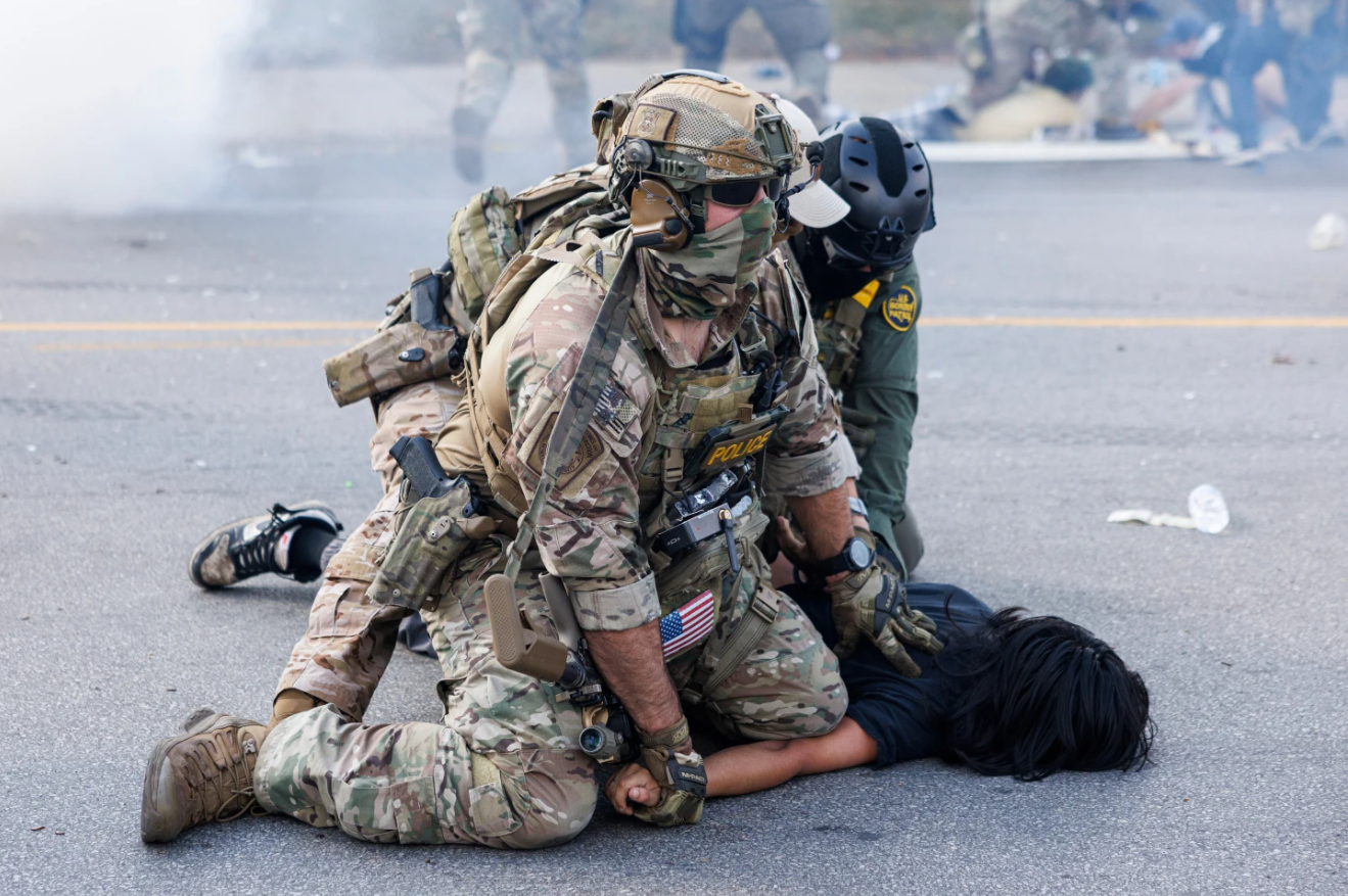 Federal officers hold down a protestor in the Brighton Park neighborhood of Chicago, on Saturday, Oct. 4, 2025, after protestors learned that U.S. Border Patrol shot a woman Saturday morning on Chicago's Southwest side. 