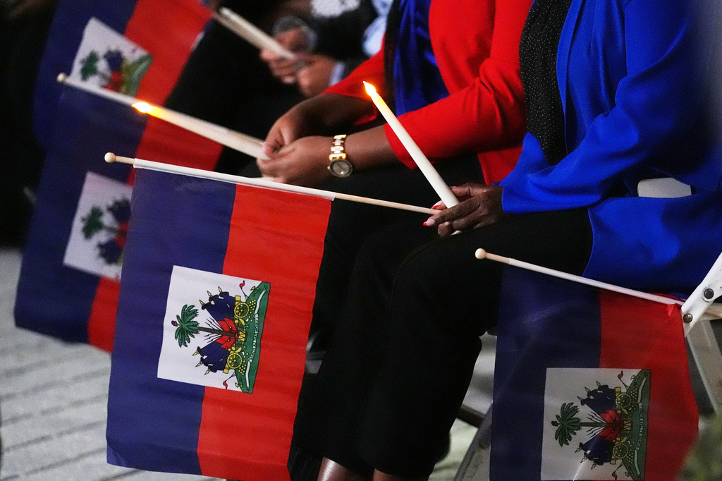 People hold Haitian flags in North Miami